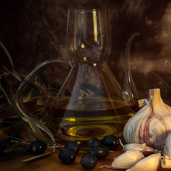 still life with jug of olive oil, garlic and black olives